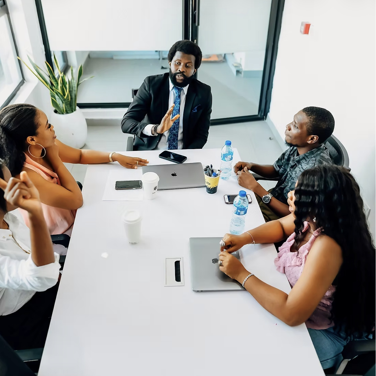 Dukia professionals in discussion around a boardroom table